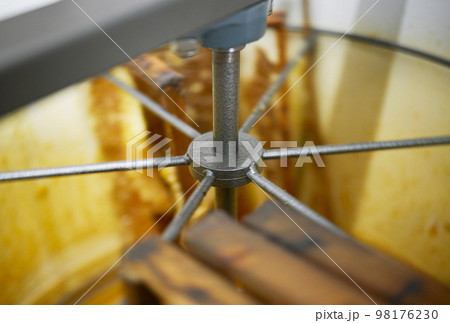 Honey production, harvest machine and manufacturing for agriculture, apiculture and sustainable industry. Factory, warehouse and food for health, organic nutrition and natural honeycomb in workshop Honey production, harvest machine and manufacturing for agriculture, apiculture and sustainable industry. Factory, warehouse and food for health, organic nutrition and natural honeycomb in workshop 98176230