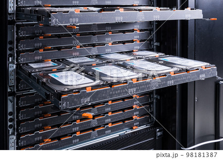 Cluster of hard drives inside open tray - a cloud data storage concept 98181387