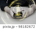 Bitcoin symbol hologram on mobile screen. Cryptocurrency and future technology concept. 98182672