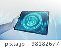 Bitcoin symbol hologram on tablet screen. Cryptocurrency and future technology concept. 98182677
