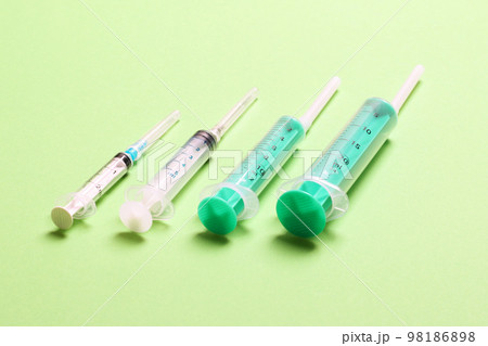 Top view of medical syringes on colorful background with copy space. Injection equipment concept Top view of medical syringes on colorful background with copy space. Injection equipment concept 98186898
