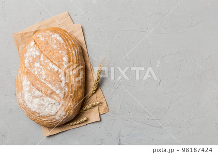 Freshly baked delicious french bread with napkin on rustic table top view. Healthy white bread loaf Freshly baked delicious french bread with napkin on rustic table top view. Healthy white bread loaf 98187424