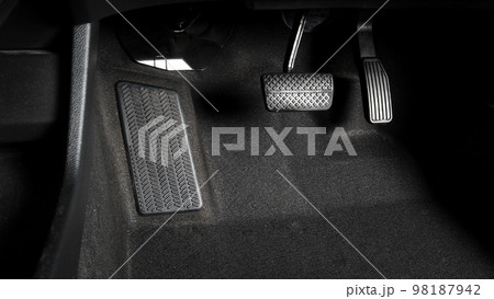 Car accelerate and brake foot pedal. Close up foot press or push foot break and accelerate pedal of a car to drive ahead. Driver driving the car by pressing or pushing accelerator pedals of the car. 98187942
