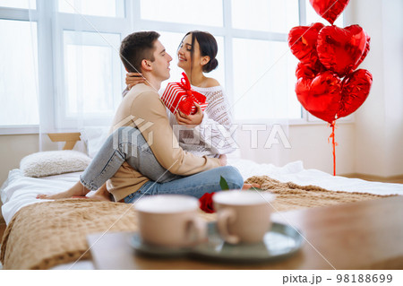 Valentine's Day concept. Happy couple in love with. Young loving couple celebrating Valentine's Day Valentine's Day concept. Happy couple in love with. Young loving couple celebrating Valentine's Day 98188699