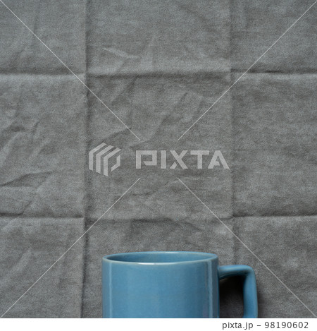 Blue mug cup on gray fabric background. top view 98190602