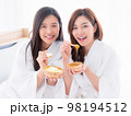 Two young women are relaxing in spa and play with skin care natural products ingredients for scrub body mask 98194512