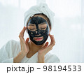 Portrait of Young woman relaxing with facial masks on white background 98194533