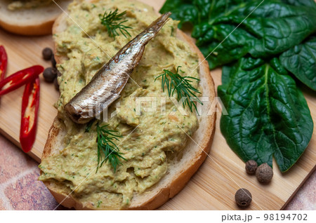 Sandwich with fish pate and sprats. Sandwich with fish pate and sprats. 98194702
