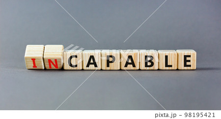 Capable or incapable symbol. Concept words Capable or Incapable on wooden cubes. Beautiful grey table grey background. Business capable or incapable concept. Copy space. 98195421
