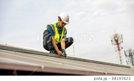 Engineer working setup Solar panel at the roof top.  98195623