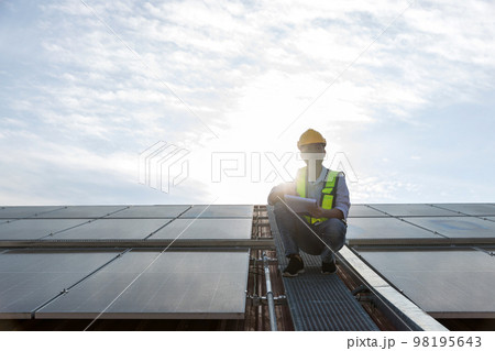 Engineer working setup Solar panel at the roof top.  98195643