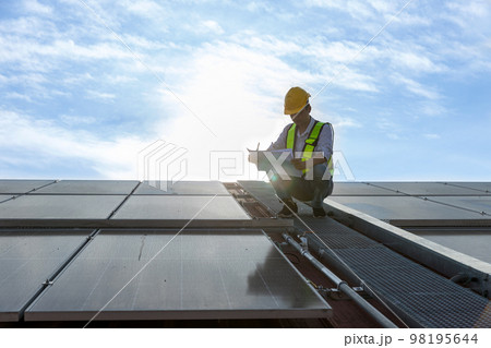 Engineer working setup Solar panel at the roof top.  98195644