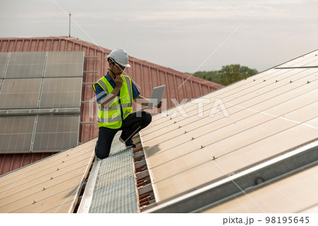 Engineer working setup Solar panel at the roof top.  98195645