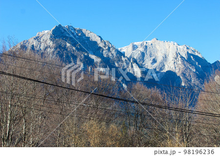 Sunny winter landscape with Bucegi mountains and Busteni ski resort in Romania. 98196236