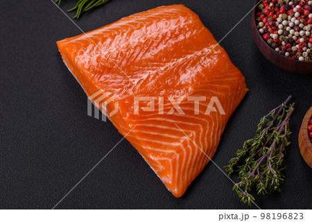 Fillet of raw red salmon fish with salt, spices and herbs 98196823