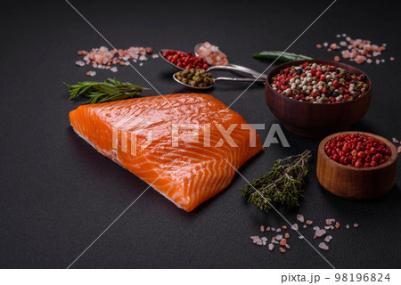 Fillet of raw red salmon fish with salt, spices and herbs 98196824