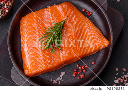 Fillet of raw red salmon fish with salt, spices and herbs 98196831