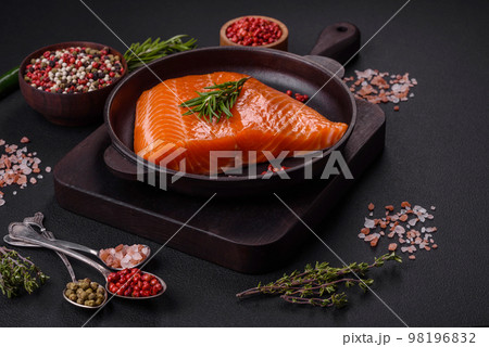 Fillet of raw red salmon fish with salt, spices and herbs 98196832
