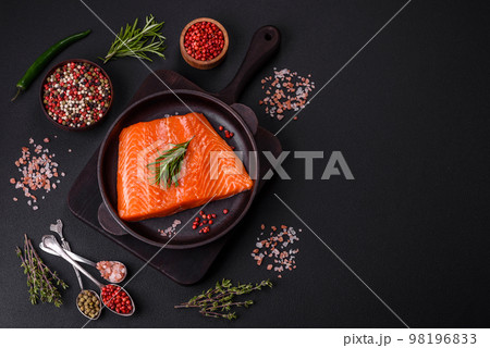 Fillet of raw red salmon fish with salt, spices and herbs Fillet of raw red salmon fish with salt, spices and herbs 98196833