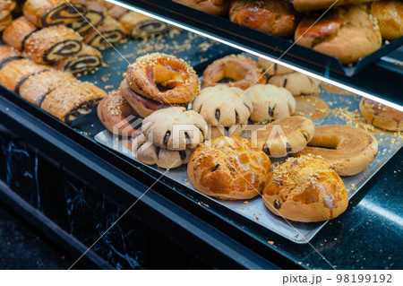 Turkish sweets biscuits pirochki rolls on a showcase in a shop in the market Turkish sweets biscuits pirochki rolls on a showcase in a shop in the market 98199192