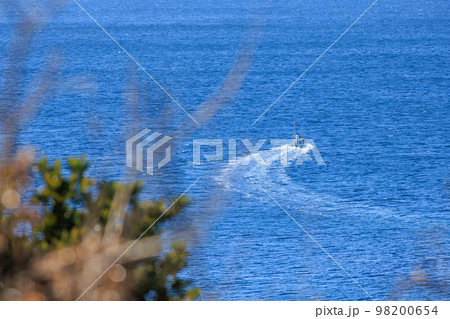 穏やかな海に出漁する漁船 98200654
