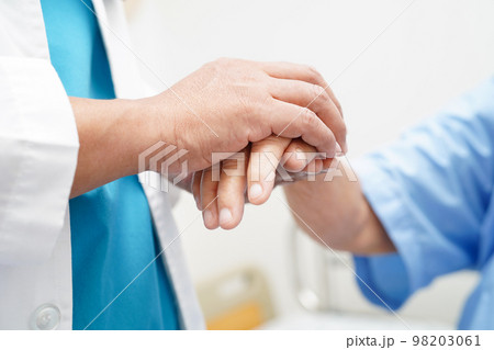 Doctor holding hands Asian elderly woman patient, help and care in hospital. Doctor holding hands Asian elderly woman patient, help and care in hospital. 98203061