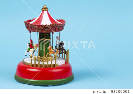 Vintage toy carousel on a blue background. Red carillon with carousel, retro carousel Vintage toy carousel on a blue background. Red carillon with carousel, retro carousel 98206001