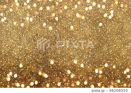 Gold bokeh. The effect of and blurring shiny balls. Defocused holiday lights. Glitter. Abstraction. 98206050