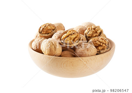 Walnuts in wooden bowl isolated on white background. Walnuts in wooden bowl isolated on white background. 98206547