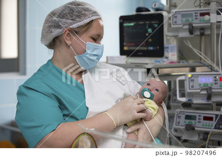 Nurse with a baby in intensive care. Newborn baby in the hospital. 98207496