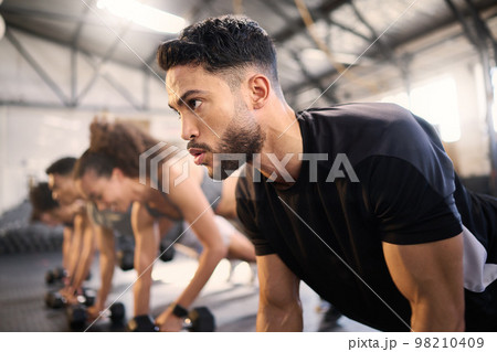 Workout class, planking and black man with motivation in a gym, fitness and exercise gym challenge. Training, sport and body balance of a athlete doing muscle cardio with commitment in wellness club 98210409
