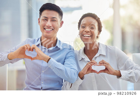 Portrait of diversity team with heart sign for corporate care, business solidarity or staff teamwork support. Asian man, African black woman or happy workforce with emoji love symbol, gesture or icon Portrait of diversity team with heart sign for corporate care, business solidarity or staff teamwork support. Asian man, African black woman or happy workforce with emoji love symbol, gesture or icon 98210926