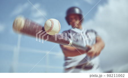 Baseball, baseball player and bat ball swing at a baseball field during training, fitness and game practice. Softball, swinging and power hit with athletic guy focus on speed, performance and pitch 98211002