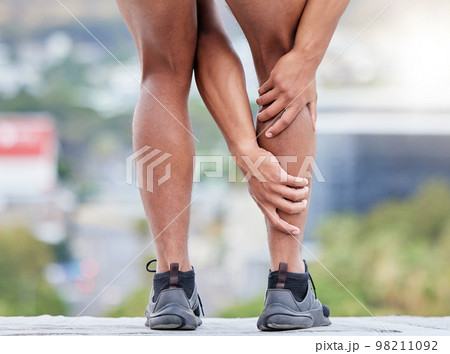 Man, fitness and legs injury on outdoor run for sports marathon, exercise emergency or wellness accident. Athlete, healthy workout and cardio runner leg pain or calf muscle care in city street Man, fitness and legs injury on outdoor run for sports marathon, exercise emergency or wellness accident. Athlete, healthy workout and cardio runner leg pain or calf muscle care in city street 98211092