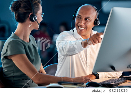 Call center, customer service and contact us, training and team leader help coworker, crm and communication at computer with headphone. Telemarketing, man and woman working together, support and call 98211336