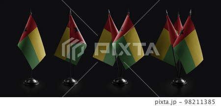 Small national flags of the Guinea Bissau on a black background 98211385