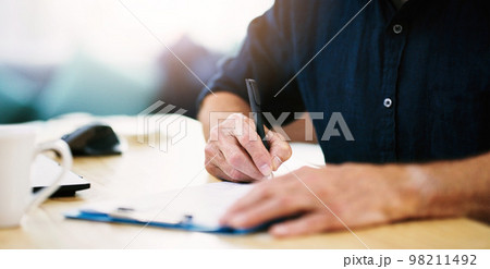 Notes, planning and hands of businessman writing on paper, documents and form in house. Administration, paperwork and remote employee working and giving signature on a contract for entrepreneur work 98211492