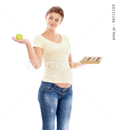 Woman, pregnant and studio with choice, apple or chocolate for nutrition, health and wellness. Pregnant woman, healthy fruit or candy with decision for diet, healthcare and isolated white background 98213109