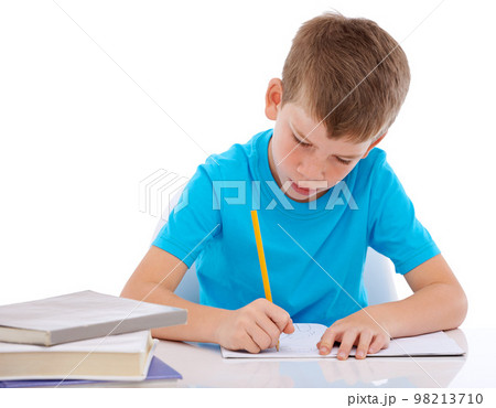 Young boy, writing and learning homework at desk for school, education and student knowledge. Paper, working and child with books for study, creative drawing or academic preschool practice in studio Young boy, writing and learning homework at desk for school, education and student knowledge. Paper, working and child with books for study, creative drawing or academic preschool practice in studio 98213710