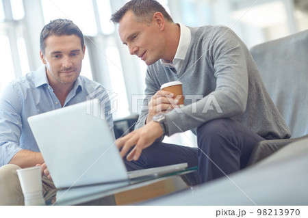 Negotiation meeting, businessman or clients on laptop in company lobby for strategy, planning or feedback. Professional people, financial advisor or employee talking to partner of startup investment 98213970