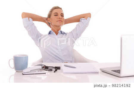 Corporate, working and relax with a business woman in studio on a white background sitting hands behind head. Laptop, success and coffee with a female employee feeling relaxed at her work desk 98214192
