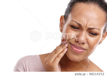 Woman, hand and mouth in pain from wisdom teeth, surgery or dental emergency against a white studio background. Isolated female suffering from painful oral, gum or tooth injury on white background 98214252