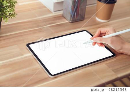 holding digital pen and using tablet mockup of blank screen. Take your screen to put on advertising. 98215543