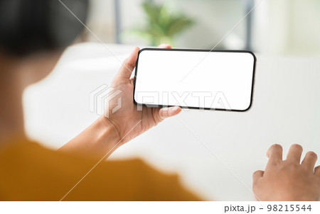 Hand holding digital smartphone mockup of blank screen. Take your screen to put on advertising. 98215544