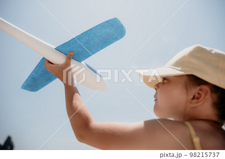 Kid playing with toy airplane. Children dream of travel by plane 98215737