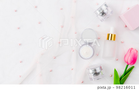 Cosmetic bottle, ingredients for skin care and treatment vitamin on cloth background Cosmetic bottle, ingredients for skin care and treatment vitamin on cloth background 98216011