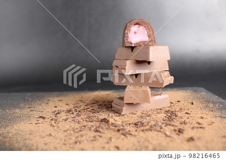 Three chocolate couscous lie on the cocoa on a black grey background with room for a copy of the chocolate brown chocolate table 98216465