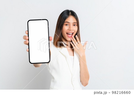 Beautiful Asian woman holding smartphone mockup of blank screen and smiling on white background. 98216660