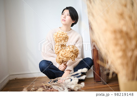 ドライフラワーを持つ女性ポートレート 98219148