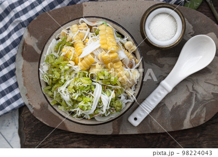 Pounded unripe rice Flakes Cereal (Khao Mao) and Steamed Sweet Corn mixed with Grated young Coconut flesh. 98224043